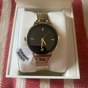Gold Ann Klein watch with rich black face and bracelet style band with classic